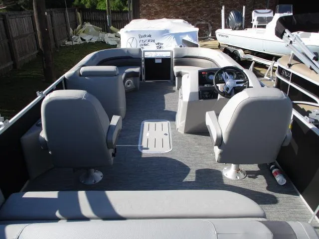 Slide: The Image of 2024 Bennington 22SXSB pontoon boat interior with gray seating and steering console. - 8