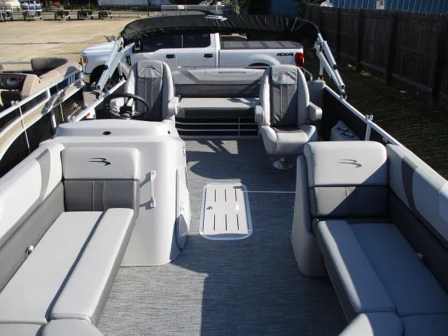 Slide: The Image of 2024 Bennington 22SXSB pontoon boat interior with gray seating and steering console. - 9