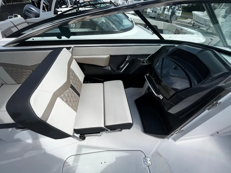 Slide: The Image of 2024 Monterey 275SS boat interior with white and beige seating. - 11
