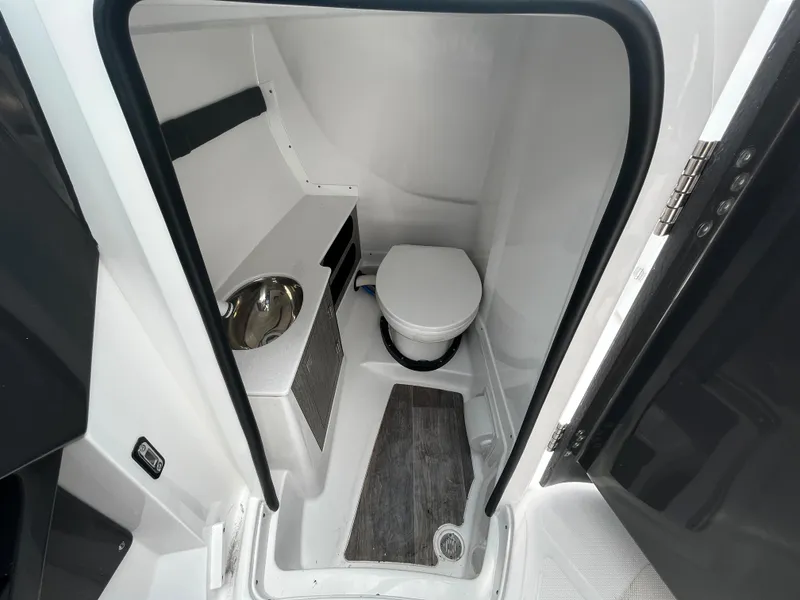 Slide: The Image of 2024 Monterey 275SS boat interior bathroom with toilet and sink. - 12