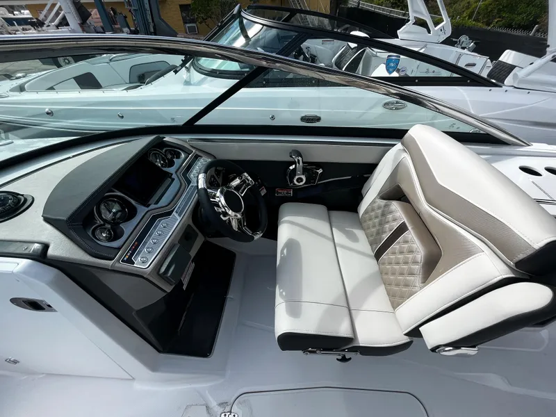 Slide: The Image of 2024 Monterey 275SS boat cockpit with modern dashboard and luxurious seating. - 13