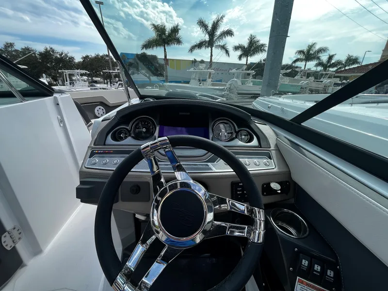 Slide: The Image of 2024 Monterey 275SS boat dashboard with steering wheel and instrument panel. - 14