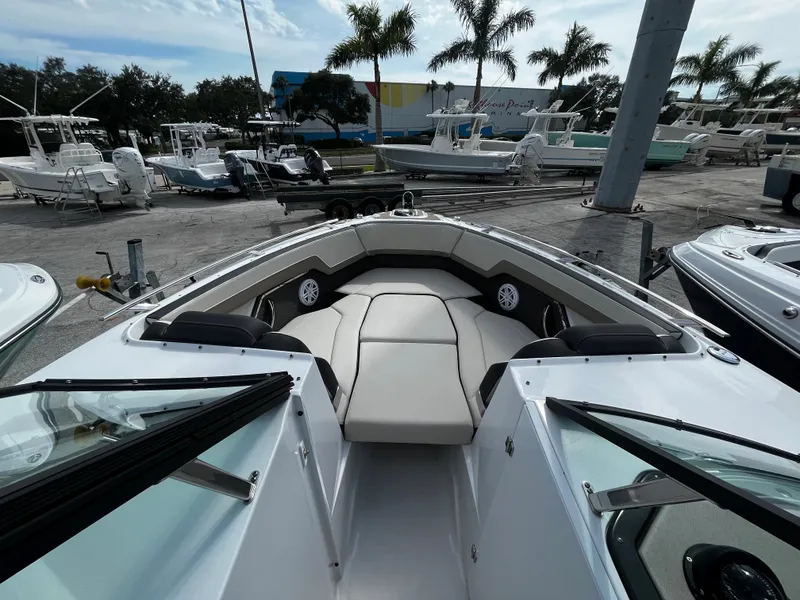 Slide: The Image of 2024 Monterey 275SS boat with spacious bow seating at a marina. - 16
