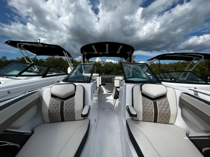 Slide: The Image of 2024 Monterey 275SS boat with luxurious seating and sleek design under a cloudy sky. - 20