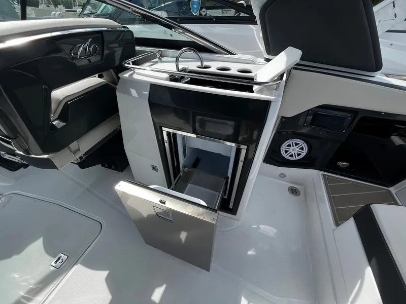 Slide: The Image of 2024 Monterey 275SS boat interior with open storage compartment and seating area. - 22