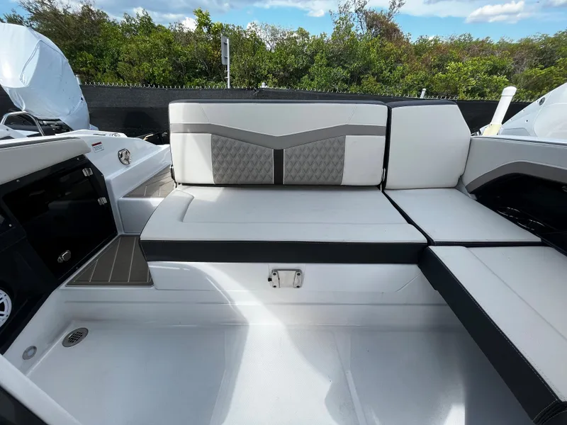 Slide: The Image of 2024 Monterey 275SS boat interior with white and gray seating. - 8