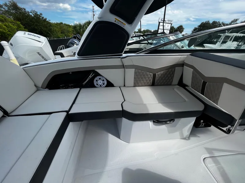 Slide: The Image of 2024 Monterey 275SS boat interior with cushioned seating and storage. - 9