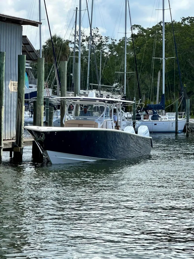 Slide: The Image of 2024 Jupiter 43 boat docked in a marina with sailboats. - 1