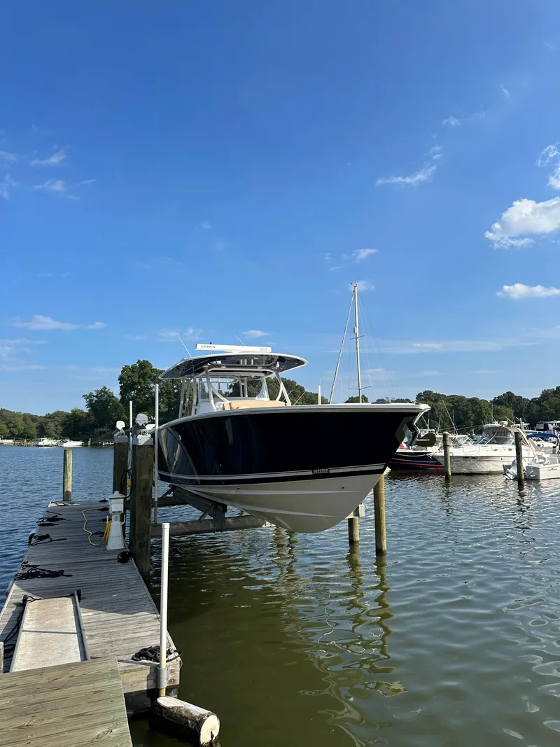 Slide: The Image of 2024 Jupiter 43 boat docked at a marina on a sunny day. - 11