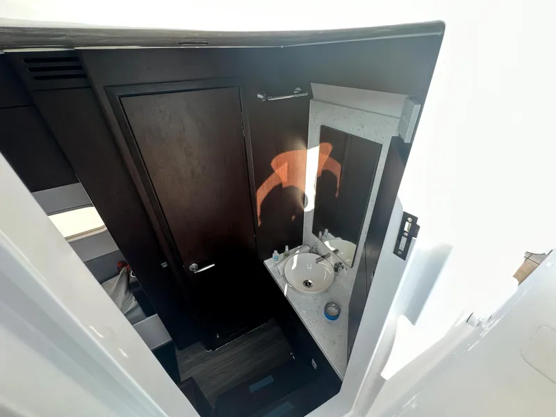 Slide: The Image of 2024 Jupiter 43 boat interior bathroom with sink and mirror. - 27