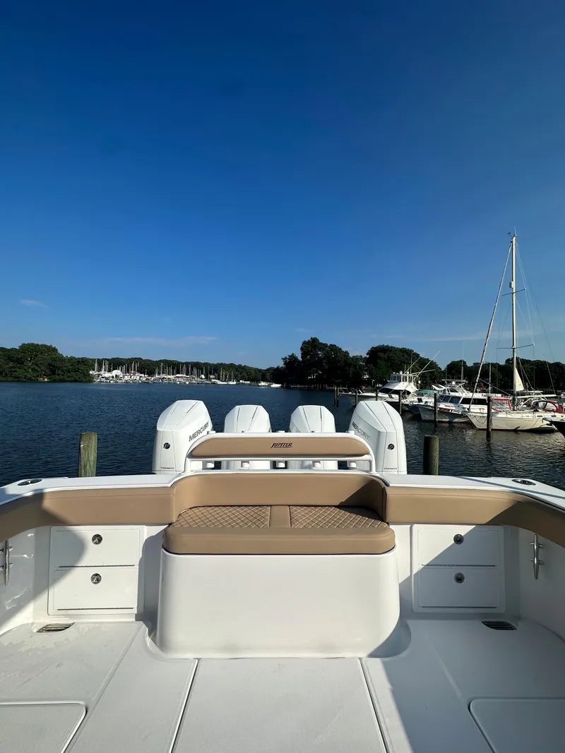 Slide: The Image of 2024 Jupiter 43 boat docked at a marina on a sunny day. - 3