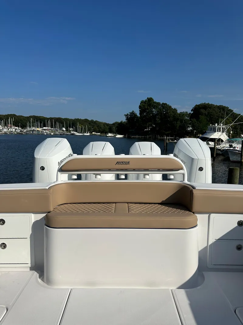 Slide: The Image of 2024 Jupiter 43 boat with quad engines docked at a marina. - 36