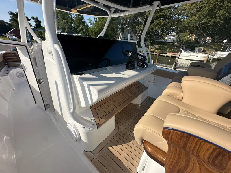 Slide: The Image of 2024 Jupiter 43 boat cockpit with helm station and luxurious seating. - 39