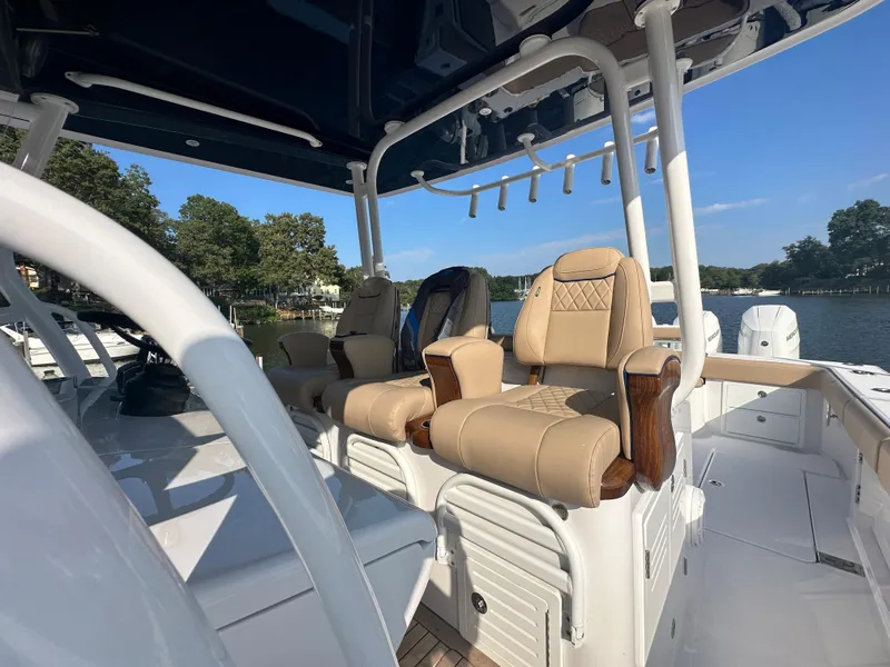 Slide: The Image of 2024 Jupiter 43 boat with luxurious seating and scenic waterfront view. - 40