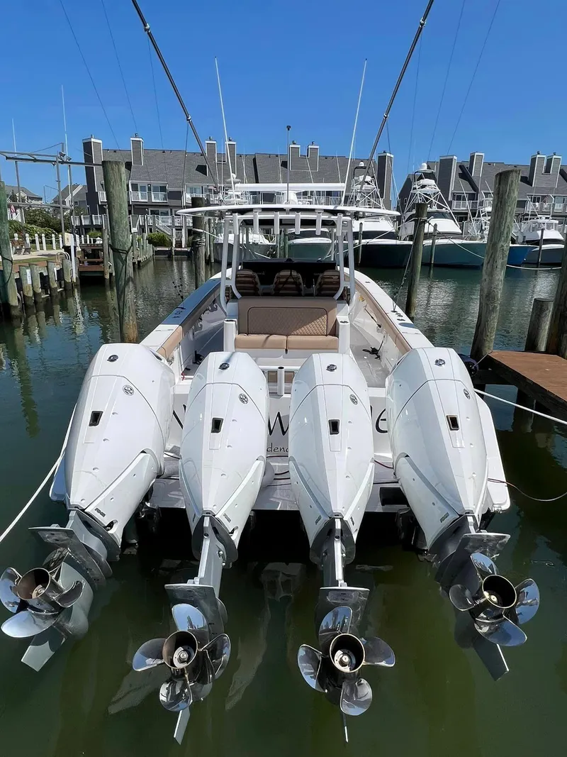 Slide: The Image of 2024 Jupiter 43 boat with four outboard engines docked at marina. - 9