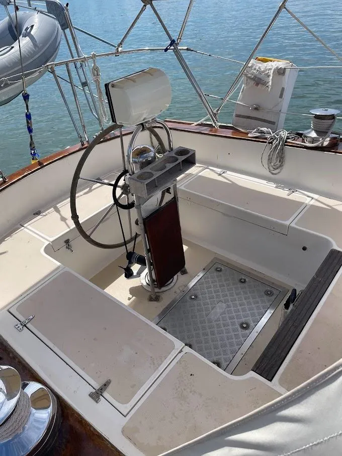 Slide: The Image of 1977 Gulfstar 37 sailboat cockpit with steering wheel and nautical equipment. - 2