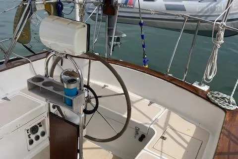 Slide: The Image of Cockpit of a 1977 Gulfstar 37 sailboat with steering wheel and control panel. - 3
