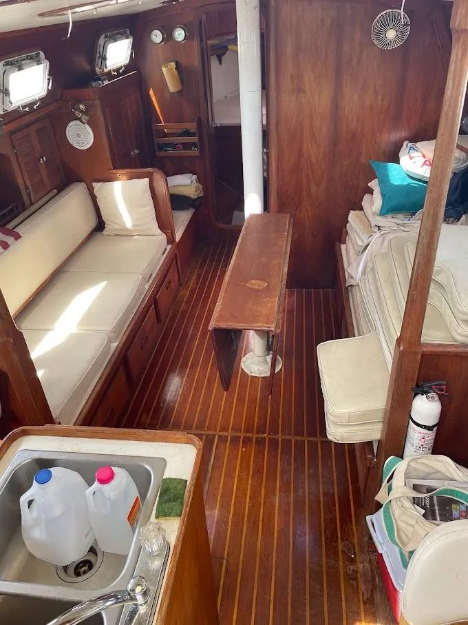 Slide: The Image of Interior of 1977 Gulfstar 37 sailboat with wooden furnishings and cozy seating area. - 6