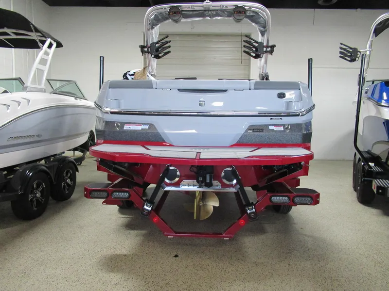 Slide: The Image of 2024 MasterCraft NXT 22 boat, rear view, in showroom. - 3