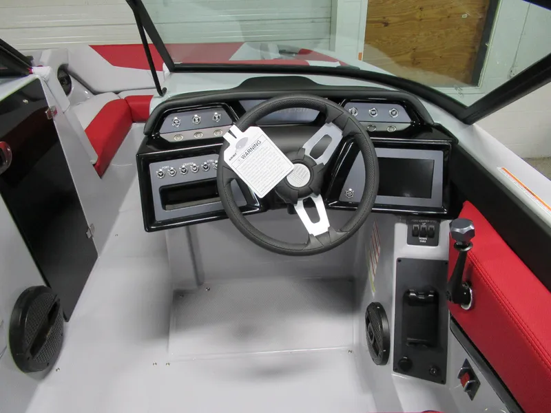Slide: The Image of 2024 MasterCraft NXT 22 boat dashboard with steering wheel and control panel. - 7
