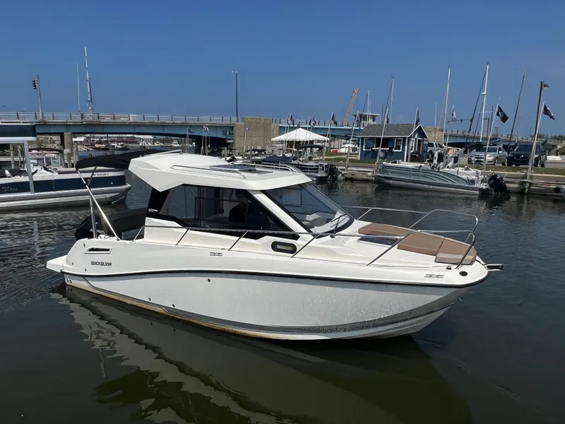 The Image of 2023 Quicksilver 675 Weekend Cruiser boat docked in a marina. - 0