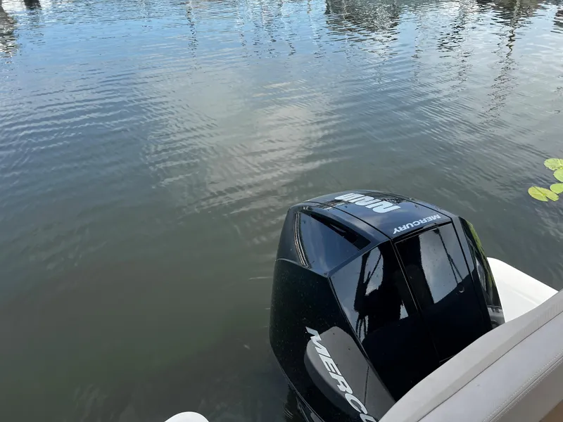 Slide: The Image of Outboard motor of 2023 Quicksilver 675 Weekend Cruiser on calm water. - 12