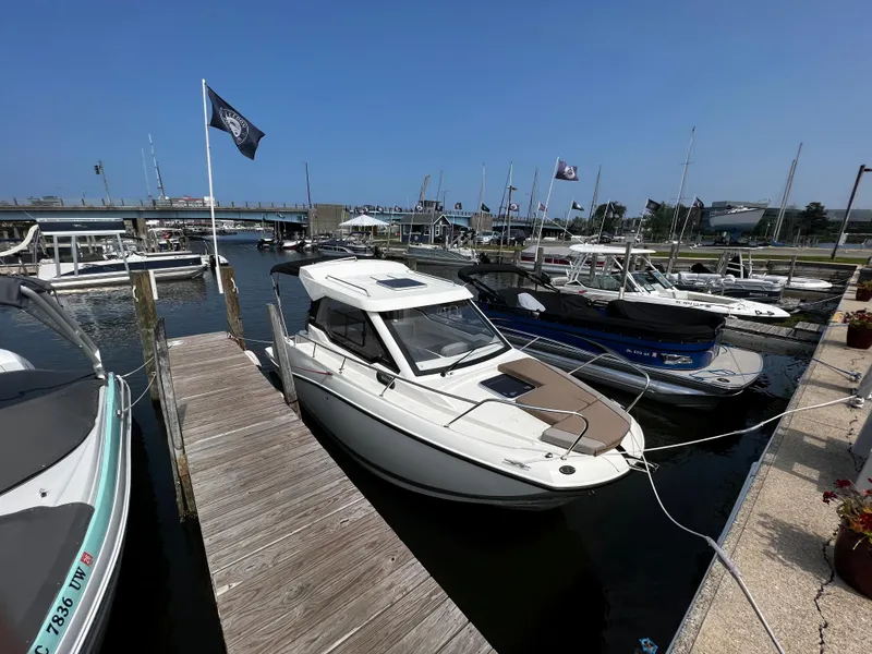 Slide: The Image of 2023 Quicksilver 675 Weekend Cruiser docked at a marina. - 2