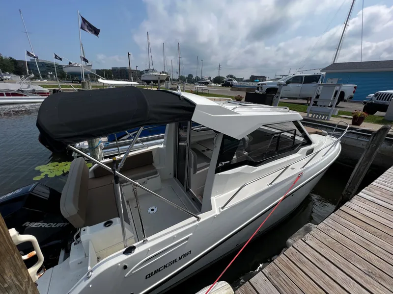 Slide: The Image of 2023 Quicksilver 675 Weekend Cruiser docked at a marina. - 3