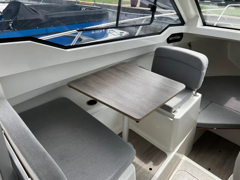 Slide: The Image of Interior of 2023 Quicksilver 675 Weekend Cruiser with seating and table. - 6