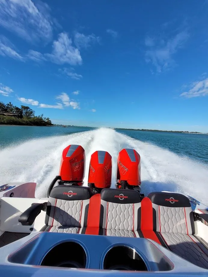 Slide: The Image of 2025 Fountain 38 SC speedboat with triple outboard engines cruising on open water. - 26