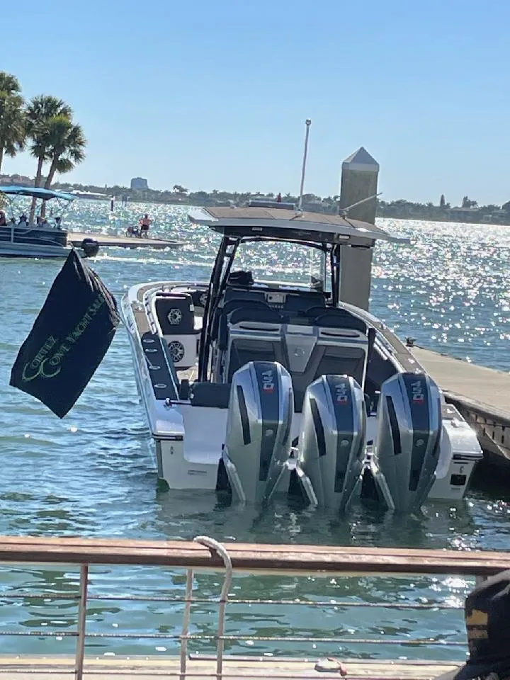 Slide: The Image of 2025 Fountain 38 SC boat docked with triple outboard engines on a sunny day. - 6