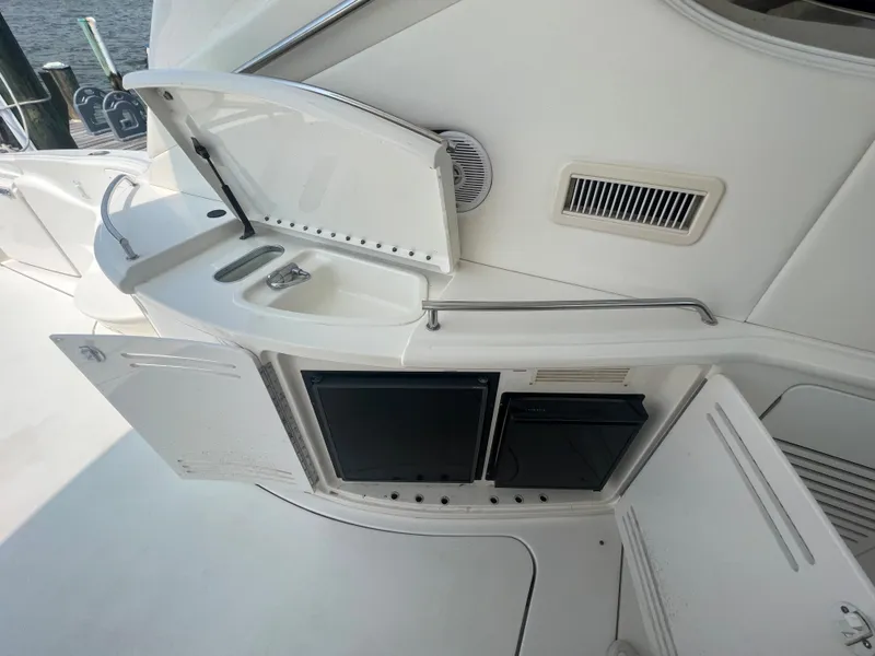 Slide: The Image of Outdoor kitchenette on a 2000 Sea Ray 540 Sundancer yacht with sink and storage. - 10