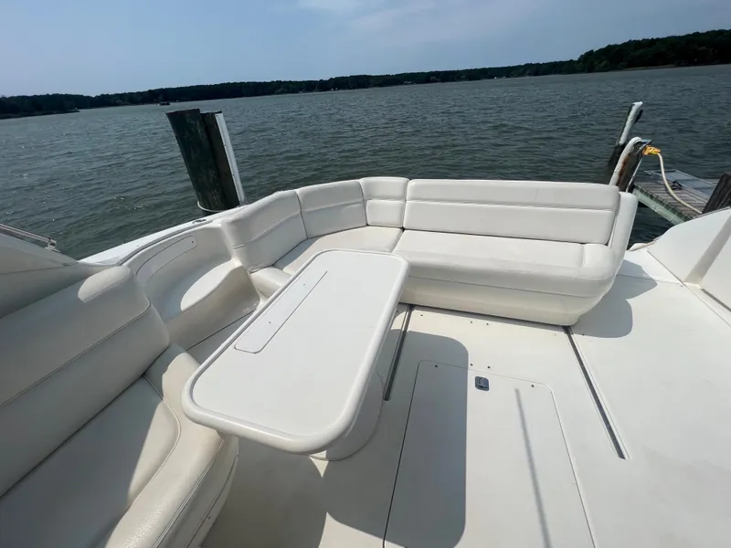 Slide: The Image of 2000 Sea Ray 540 Sundancer yacht with white leather seating and table on deck. - 3