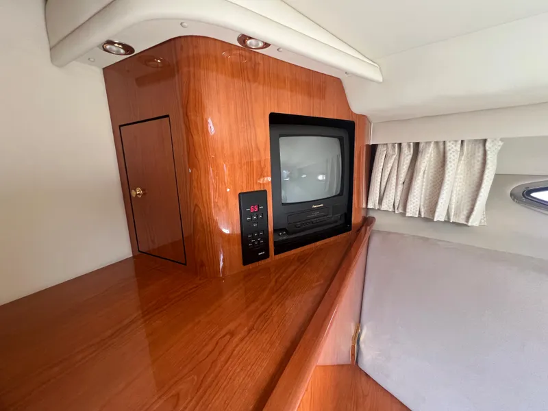Slide: The Image of Interior of 2000 Sea Ray 540 Sundancer with TV and wooden cabinetry. - 41