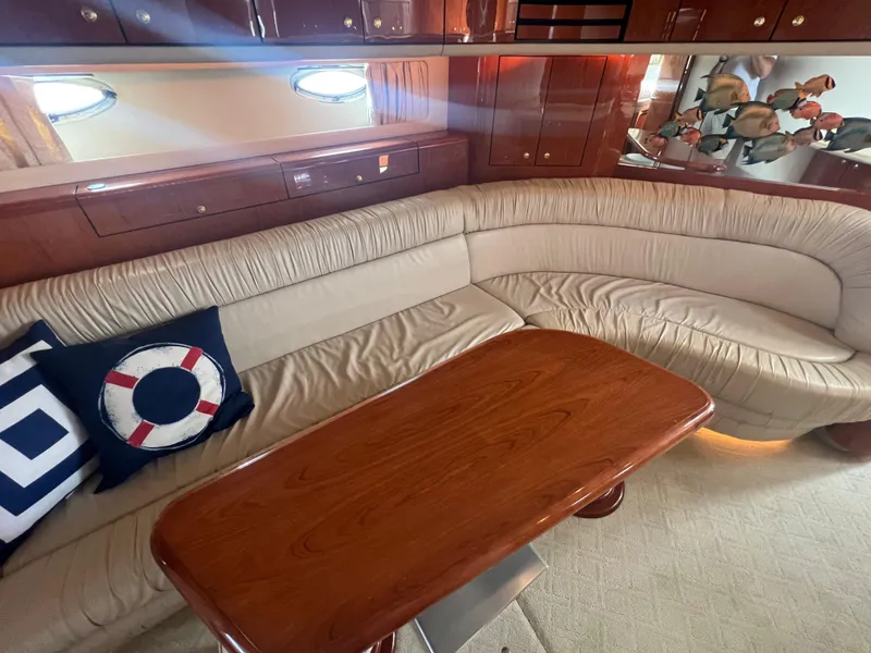 Slide: The Image of Luxurious interior of 2000 Sea Ray 540 Sundancer with plush seating and wooden table. - 47