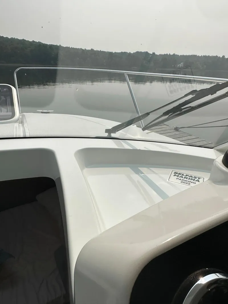 Slide: The Image of 2020 Beneteau Antares 8 OB boat interior with windshield view on calm water. - 11
