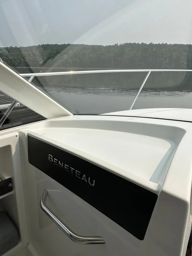 Slide: The Image of Beneteau Antares 8 OB 2020 boat interior with water and forest background. - 12