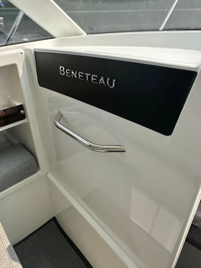 Slide: The Image of Interior of a 2020 Beneteau Antares 8 OB boat showing brand logo and handle. - 13