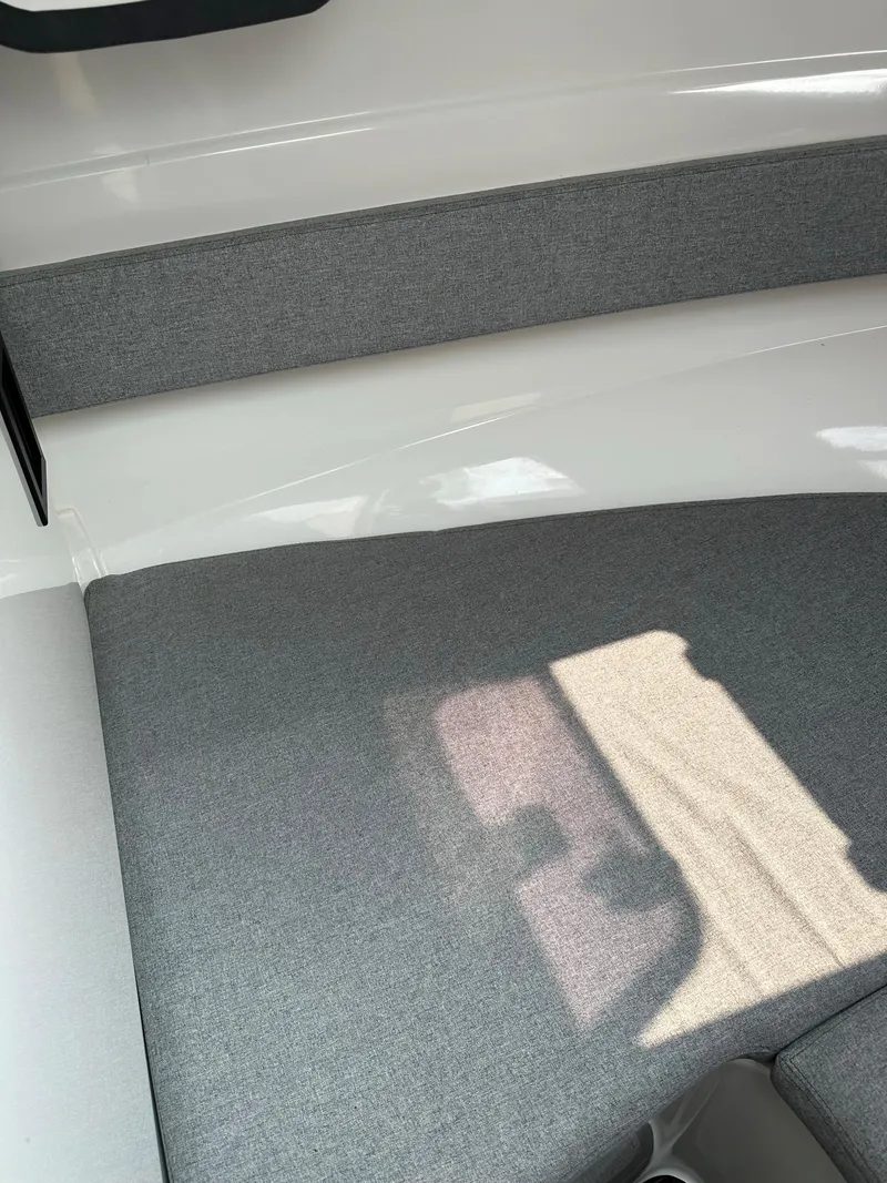 Slide: The Image of Interior seating of 2020 Beneteau Antares 8 OB boat with grey cushions. - 15