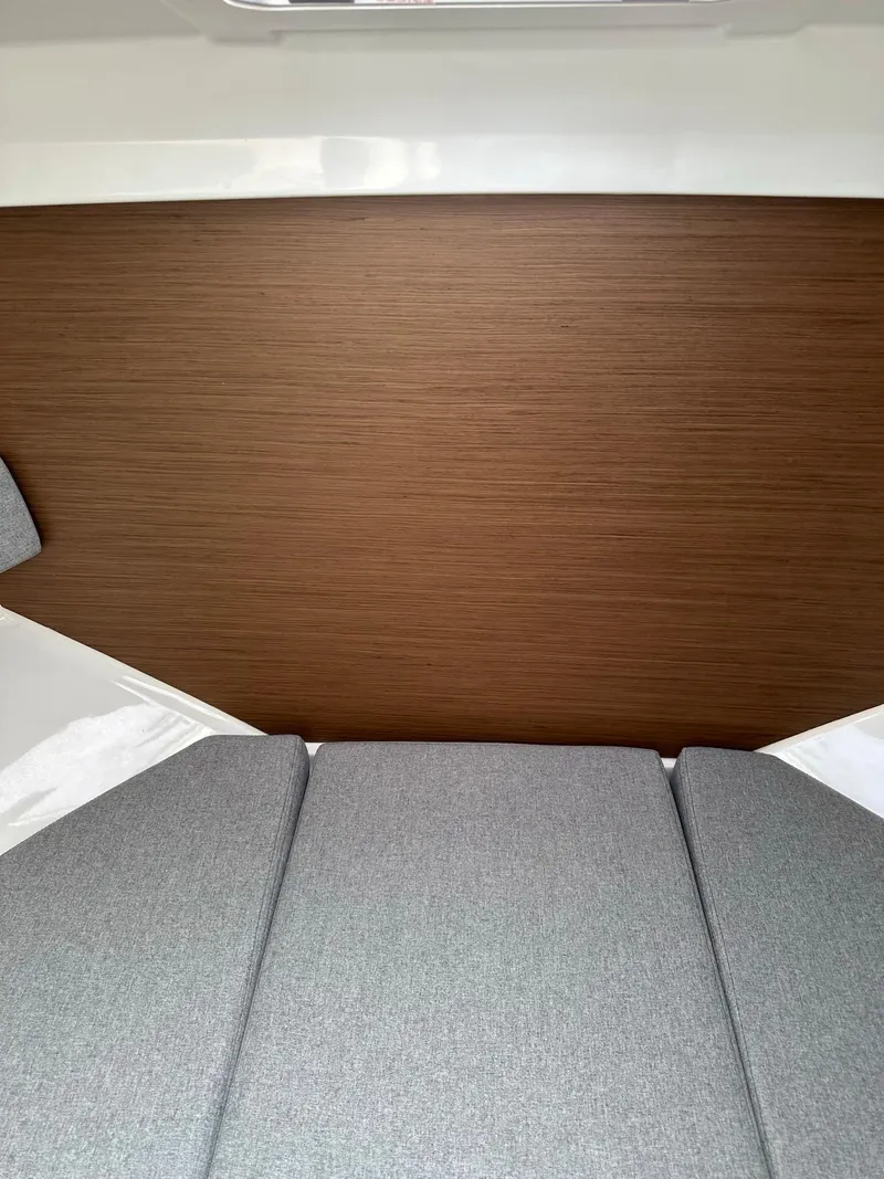 Slide: The Image of Interior cabin of 2020 Beneteau Antares 8 OB with grey cushions and wooden paneling. - 17