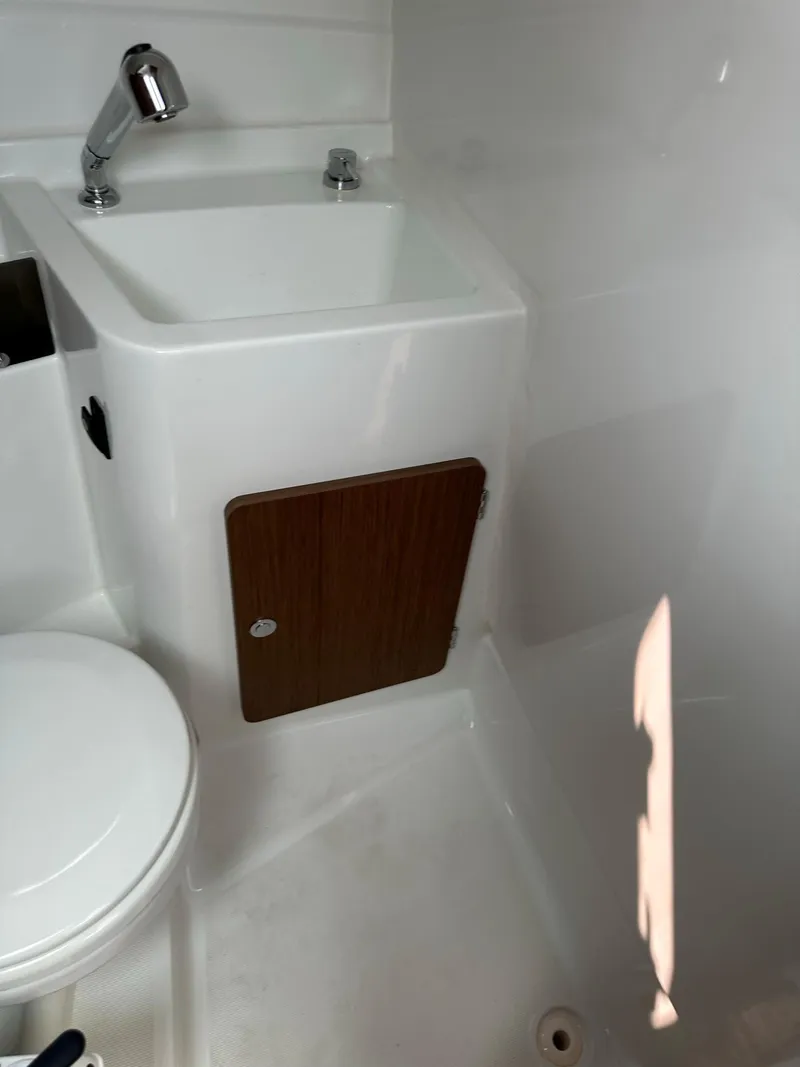 Slide: The Image of 2020 Beneteau Antares 8 OB bathroom with sink and storage cabinet. - 20