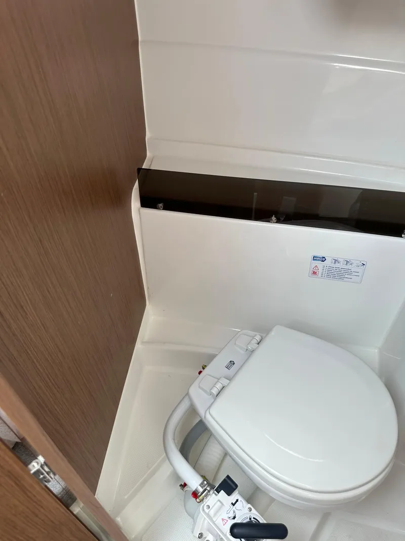 Slide: The Image of 2020 Beneteau Antares 8 OB boat bathroom with marine toilet. - 21