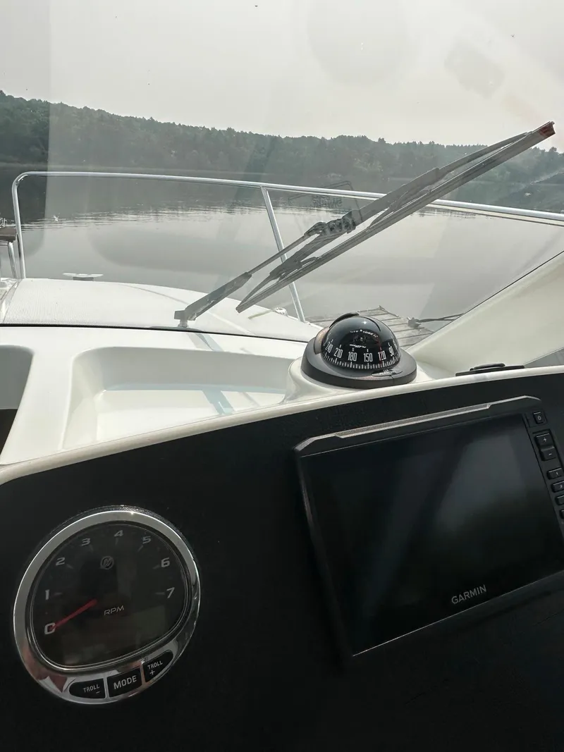 Slide: The Image of Dashboard view of a 2020 Beneteau Antares 8 OB boat with compass and Garmin display. - 22