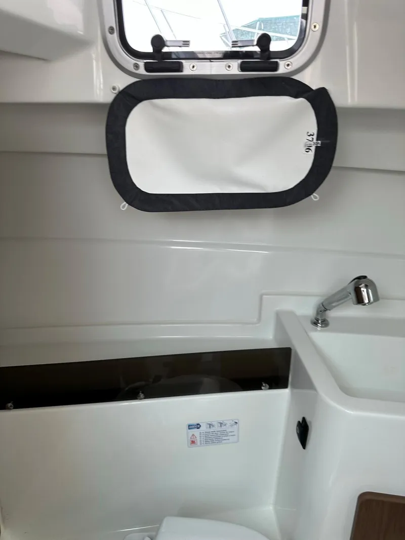 Slide: The Image of 2020 Beneteau Antares 8 OB boat interior with sink and window. - 23