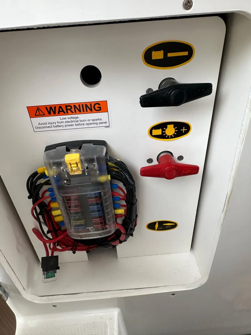 Slide: The Image of Electrical panel of a 2020 Beneteau Antares 8 OB boat with warning label. - 25