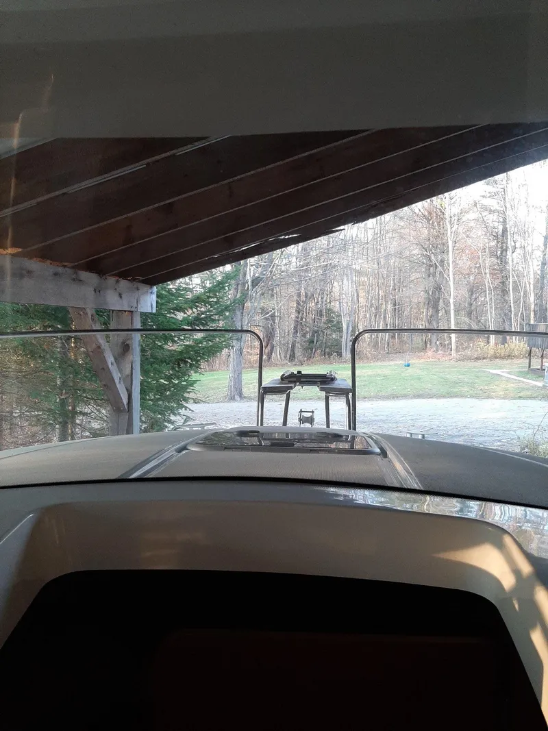 Slide: The Image of 2020 Beneteau Antares 8 OB boat under a wooden shelter. - 4