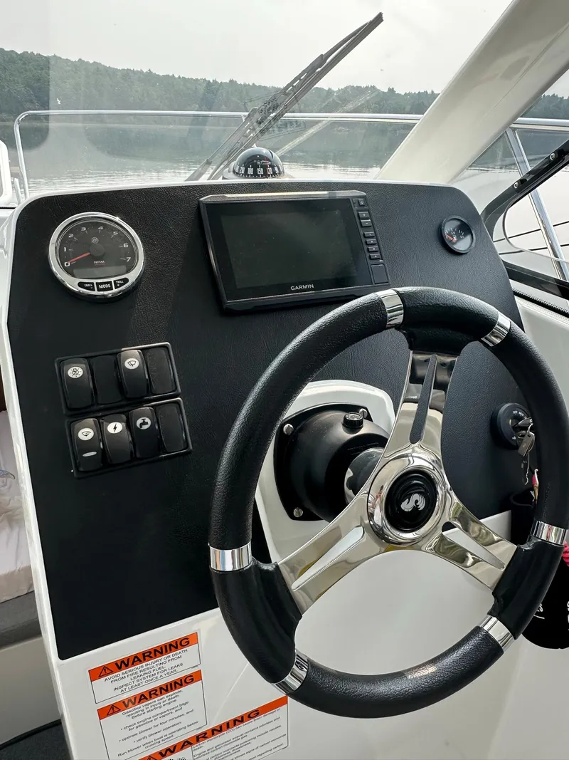 Slide: The Image of Steering console of a 2020 Beneteau Antares 8 OB boat with navigation equipment. - 5