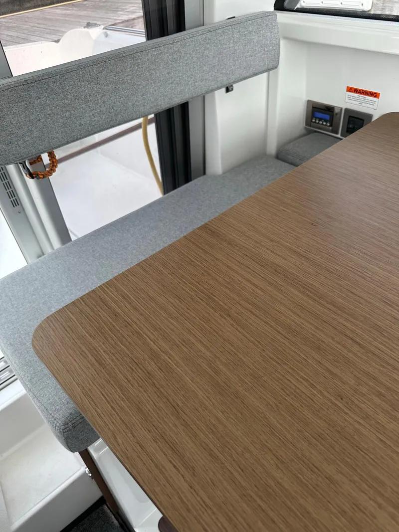 Slide: The Image of Interior seating and table of 2020 Beneteau Antares 8 OB boat. - 9