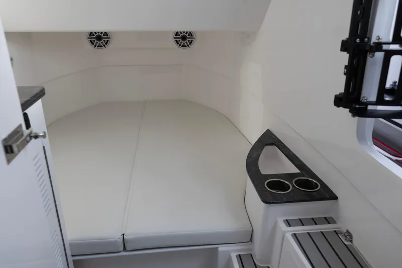Slide: The Image of Interior cabin of 2025 Fountain 43 SCX boat with cushioned seating and cup holders. - 16