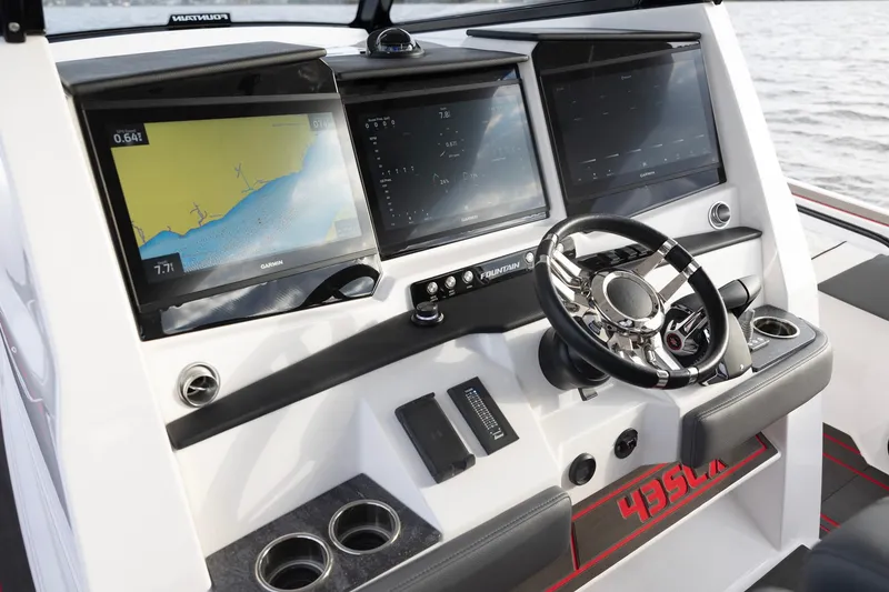 Slide: The Image of 2025 Fountain 43 SCX boat dashboard with advanced navigation screens and steering wheel. - 5